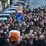 The remains of Former Deputy First Minister Martin McGuinness is carried by friends colleagues and relatives through the streets of the Bogside this afternoon.
