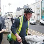 Letterkenny businessman Brendan McGlynn picks up his post from one of Letterkenny's fast pedalling team of cycling postmen. Photo: Declan Doherty