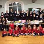 Members of the 31st Letterkenny Girls' Brigade presenting food they contributed to representatives of ÊWe Care Letterkenny FoodÊ Bank recently.