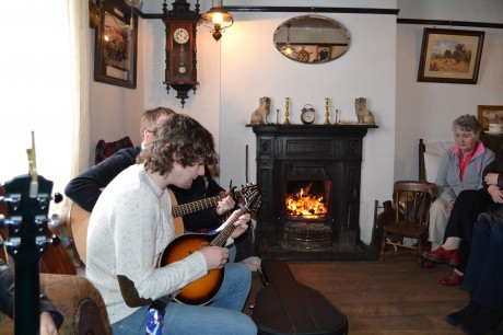 Declan McClafferty of In Their Thousands entertains by the fireside at Teach John Mickey Ban's in Carrigart.
