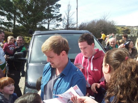 Shane and Kian signing autographs during a visit to Shane's home in Downings this week.