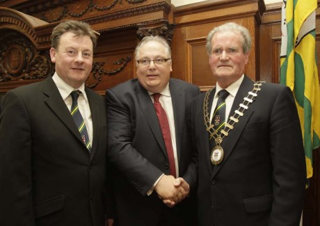 Frank McBrearty, outgoing mayor and Seamus Neely, county manager, congratulate the new county mayor Ian McGarvey at the agm on Monday.