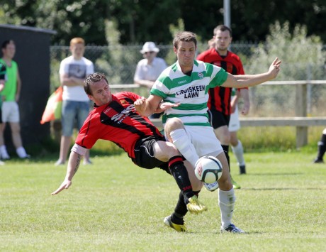 Kildrum Tigers Ronan Coyle gets the challenge in against Malachy McDermott of Cockhill Celtic. Photo: Donna McBride