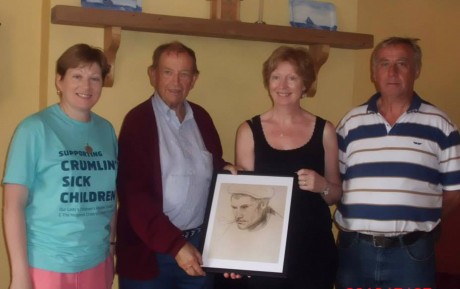 Valentine Lamb making a presentation to myself, Mairin Ui Fhearraigh of a painting by his father Henry lamb of a Gola Island Fisherman. Also pictured are Sile Ui Ghallchoir and Eamon Mac Aoidh. Photo: Michelle Nic Aoidh