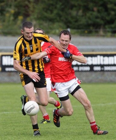St Eunan's Kevin Rafferty in action against Stephen Coyle of St Michaels. Photo: Donna McBride.