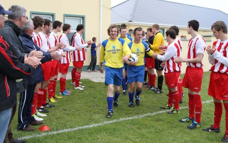 The officials and players of Keadue Rovers form a guard of honour at Strand Park, Maghery to welcome new club Strand Rovers to the Donegal Junior League on Sunday afternoon. Photo: Gary Foy