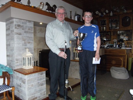 John Logue presenting Sean Sweeney , winner of the Best Junior Prize at last weeks' Mulroy Charity Sea Angling Competition