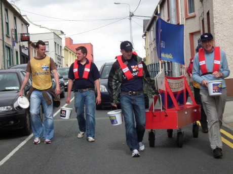 The crew make their way through Ballyshannon during last year's boat push.