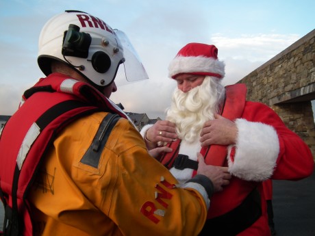 Santa gets helped into his lifejacket.