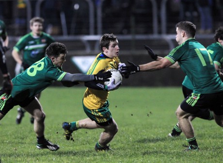 Donegal's Darach O'Connor is challenged during the match against Queen's University.