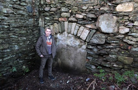 Donnan Harvey pictured at the fireplace believed to be built and used in the 17th century.