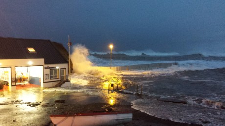 The scene at 8am on Saturday morning as the tide continues to breach the wall.