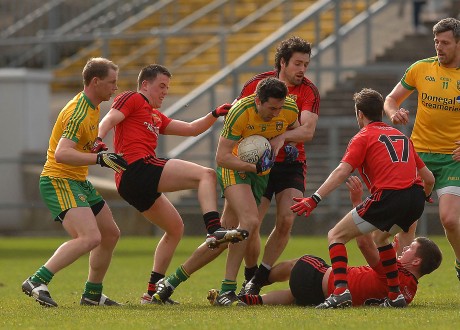 Rory Kavanagh under pressure from three Down men, in the midfield area, in the Div 2 clash in Pairc Esler, Nerwry,