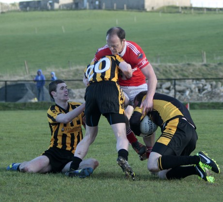St Eunan's 'keeper John Paul Clarke gathers the ball as Conor Morrison pressures Colm McFadden.