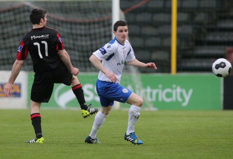 Ciaran Coll of Finn Harps has his eyes on the ball as he clears the danger against Longford Town.