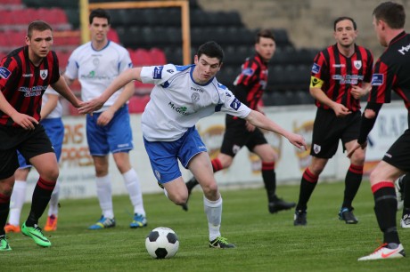 Caoimhin Bonner, making his full debut for Finn Harps, finds himself surrounded by Longford Town players.