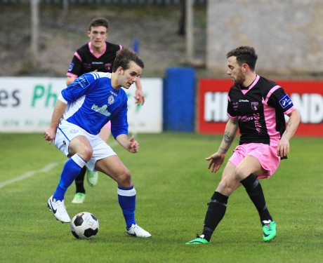 James Doherty of Finn Harps keeps possession against Wexford Youths.