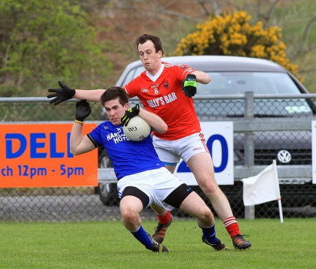 Cathal Ellis, Naomh Conaill under pressure from Michael McGinley, St Michaels. Photo: Donna El Assaad