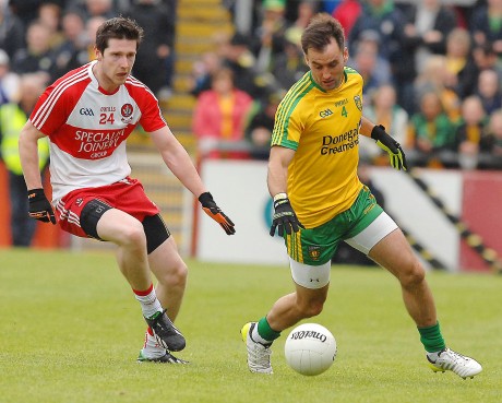 Karl Lacey, winning the ball from Derry's Emmet Bradley.