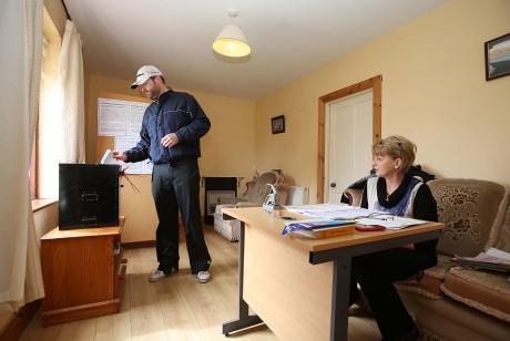 Patrick Sweeney casting his vote on Gola Island yesterday (Thursday). Included is polling officer Nancy Sharkey.