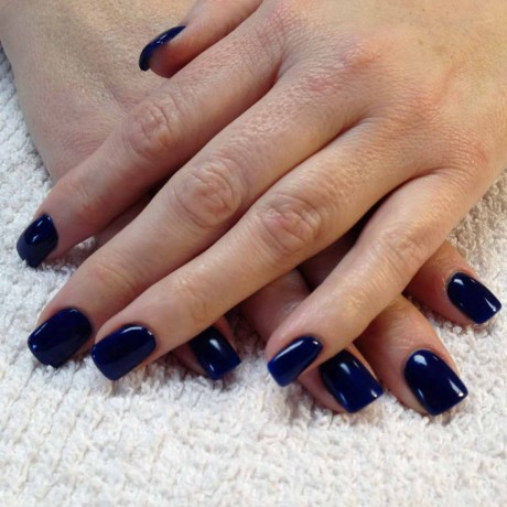 Gel nail polish on natural nails with blue colour.