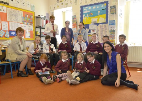 Students of Scoil Cholmcille Oilean Thorai relax with tablets and smartphones.