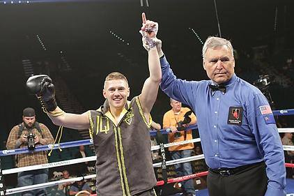 Jason Quigley's hand is raised in victory by referee Jay Nada