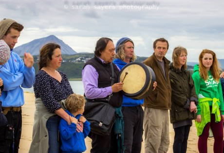 Local people gather with Native American Indian Gary (White Deer) for special prayers and a blessing of family of whales that died at Ballyness beach, Falcarragh, Donegal. Photo courtesy of Sarah Sayers