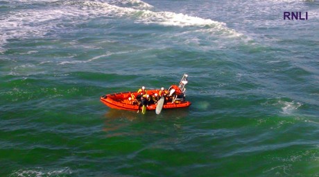 The surfers being brought onto the lifeboat yesterday evening.