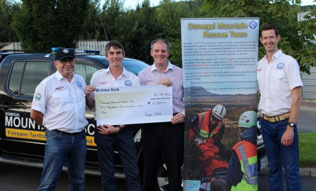 Anraí O Domhnaill presenting a cheque for  Euro: 7000.00 to Brian Murray, Joseph Brennan and Gerard Murray for Donegal Mountain Rescue Team. The money was raised from the recent Errigal climb where Anraí congratulated the DMRT members on a very wet afternoon after summitting Errigal for the 1000th time.