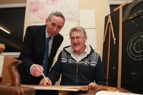 Hugh McAuley, who was a student at the Letterkenny Vocational School in the 1970s, pictured looking at mechanical drawing exercises he drew as a student. He is pictured with the present-day Principal of Errigal College, Mr Charlie Cannon, at the launch of the school's centenary. Photo: Brian McDaid