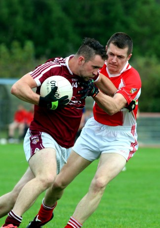 Christy Connaghan in a tussle with Gavin Ward of Dungloe in their recent game