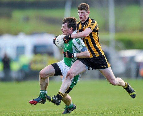 Peter Sherry, Roslea Shamrocks under pressure from Conor Morrison, St. Eunan's. Morrison is expected to play in Sunday's semi-final having been forced off injury in last week's quarter-final.