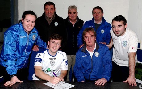 Tony Mc Namee puts pen to paper for Finn Harps as manager Ollie Horgan, Chantelle Grant, John Campbell, James Rodgers, Aidan Campbell and Shane Elliott look on. Photo: Gary Foy