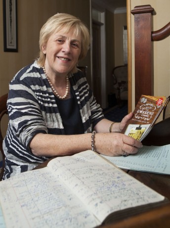 Pearl Hutchinson looks over some of the ledgers from her father's shop in Glenfin.