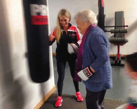 Aoife McGill at the launch of her new business with her granny giving it socks on the punch bag.