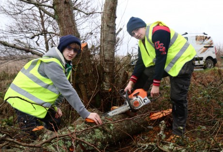 Ronan and Conor with a tree blown down in Storm Rachel.(Non-working chainsaw used as a photo prop only).