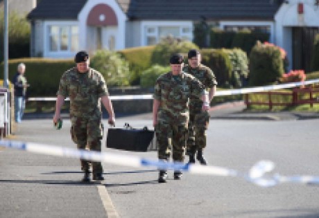 The grenade is removed from the garden at Glencar Park by members of the army explosive ordnance division on Saturday afternoon.