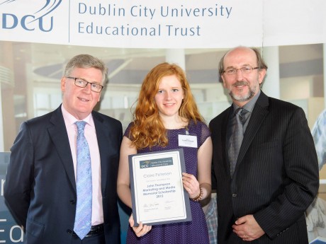 Claire Petersen being presented with her award from Mr. Larry Quinn, Chairman of the Educational Trust Board and Brian MacCraith, President of Dublin City University.