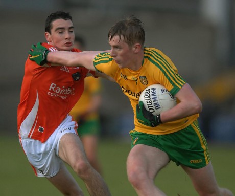 Donegal forward Rory Carr brushes past the challenge of Armagh's Ryan Owens.