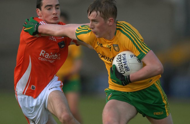 Donegal forward Rory Carr brushes past the challenge of Armagh's Ryan Owens.