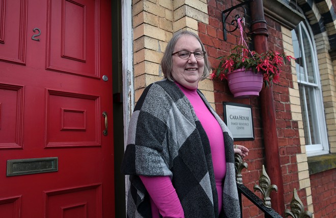 Founder, Susan-McCauley at the famous red door of Cara House.