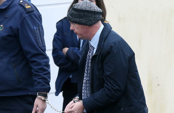 Julian Cuddihy is led into Letterkenny District Court earlier this morning