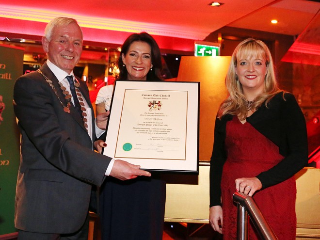 Donegal Association president Hugh Harkin and chairperson Elaine Caffrey presenting Deirdre McGlone, Harvey's Point Hotel, with the framed certificate. Deirdre is the current Donegal Person of the Year by the Donegal Association in Dublin. 