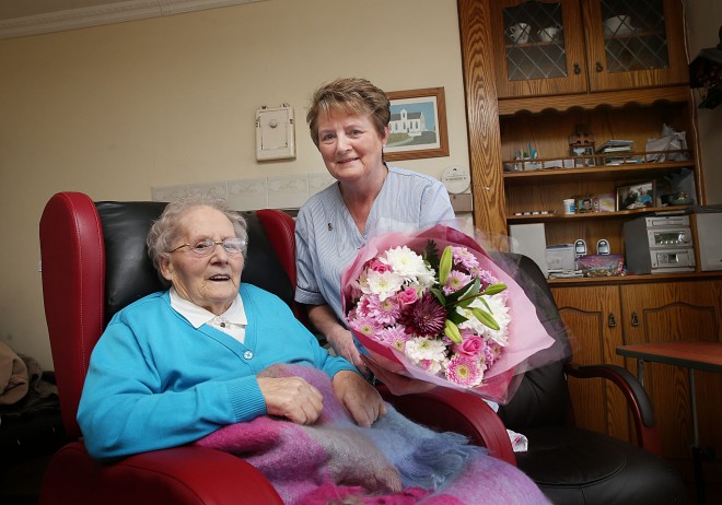 Grace Doherty (90) presenting a bouquet of flowers to home help Sally McLaughlin following her last visit to her home at Ballymaghey, Fanad this week.