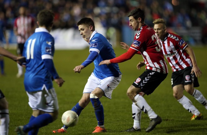 Finn Harps Ryan Curran gets the pass away against Aaron Barry of Derry City Photo: Donna El Assaad