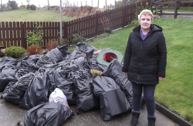 Primrose Rankin with bags of rubbish she collected