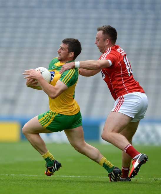 Paddy McGrath of Donegal in action against Paul Kerrigan of Cork.