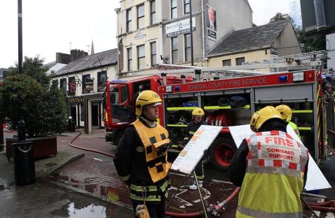 Fire service personnel at the scene of a fire in a storeroom at the Central Bar, Letterkenny this morning.
