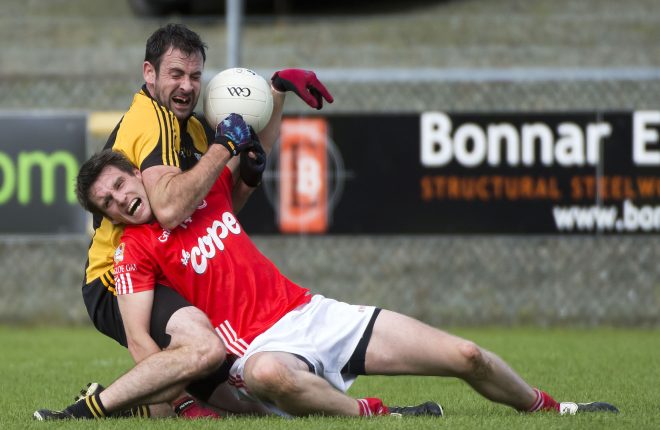Anthony Kelly and Dungloe's Noel McBride get tangled during Sunday's quarter final. Photo Evan Logan